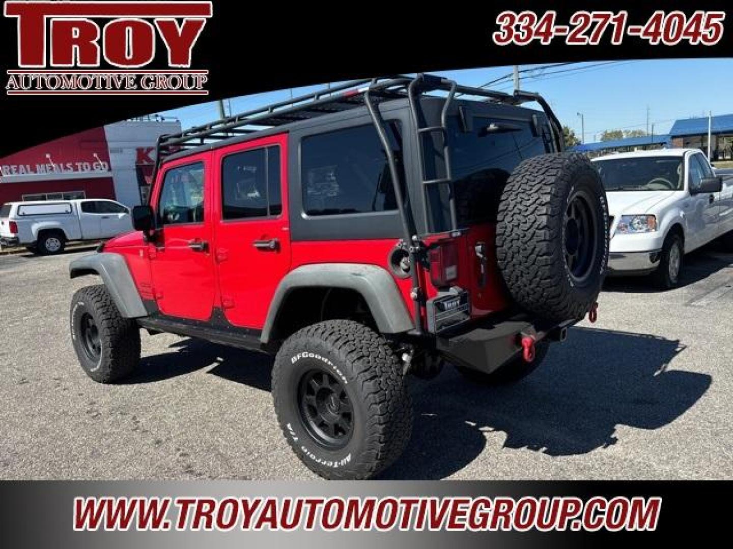 2015 Firecracker Red Clear Coat /Black Jeep Wrangler Unlimited Sport (1C4BJWDG8FL) with an 3.6L V6 24V VVT engine, Automatic transmission, located at 6812 Atlanta Hwy, Montgomery, AL, 36117, (334) 271-4045, 32.382118, -86.178673 - Fox Lift Kit!!<br>Warm Winch!!<br>Method Wheels w/BFG A/T Tires!! 35S with Full matching spare!!<br>GOBI Full Roof Rack!!<br>JW Speaker Headlights!<br>Bartact Front/Rear Seat Covers!!<br>Genesis Dual Battery Kit!! ($900)<br><br><br><br>Firecracker Red Clear Coat 2015 Jeep Wrangler Unlimited Sport 4W - Photo#12